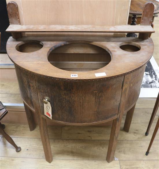 An Arts & Crafts bowfront wash stand, W.91cm